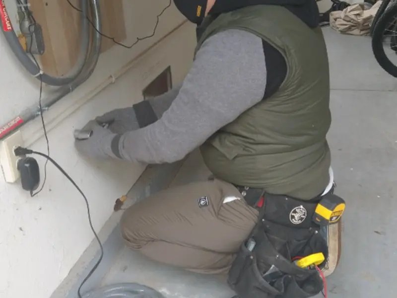 Electrician performing outlet wiring in a East Pikeland garage